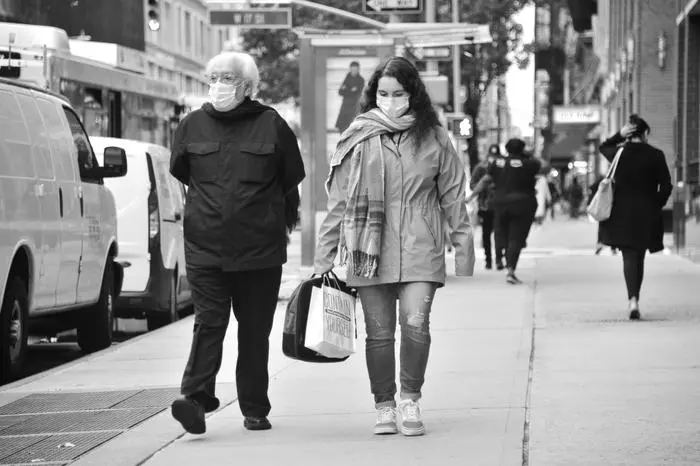 Urban street scene with masked pedestrians